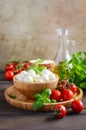 Italian food ingredients Ã¢â¬â mozzarella, tomatoes, basil and olive oil on rustic wooden table. Royalty Free Stock Photo